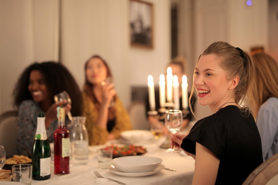 A group of people sitting around a table enjoying a holiday meal.