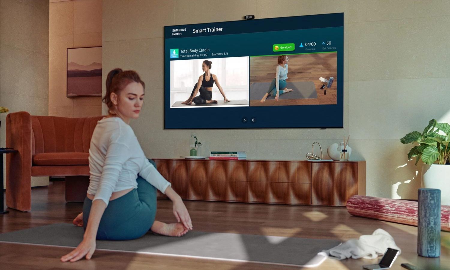 Woman doing yoga in front of a TV